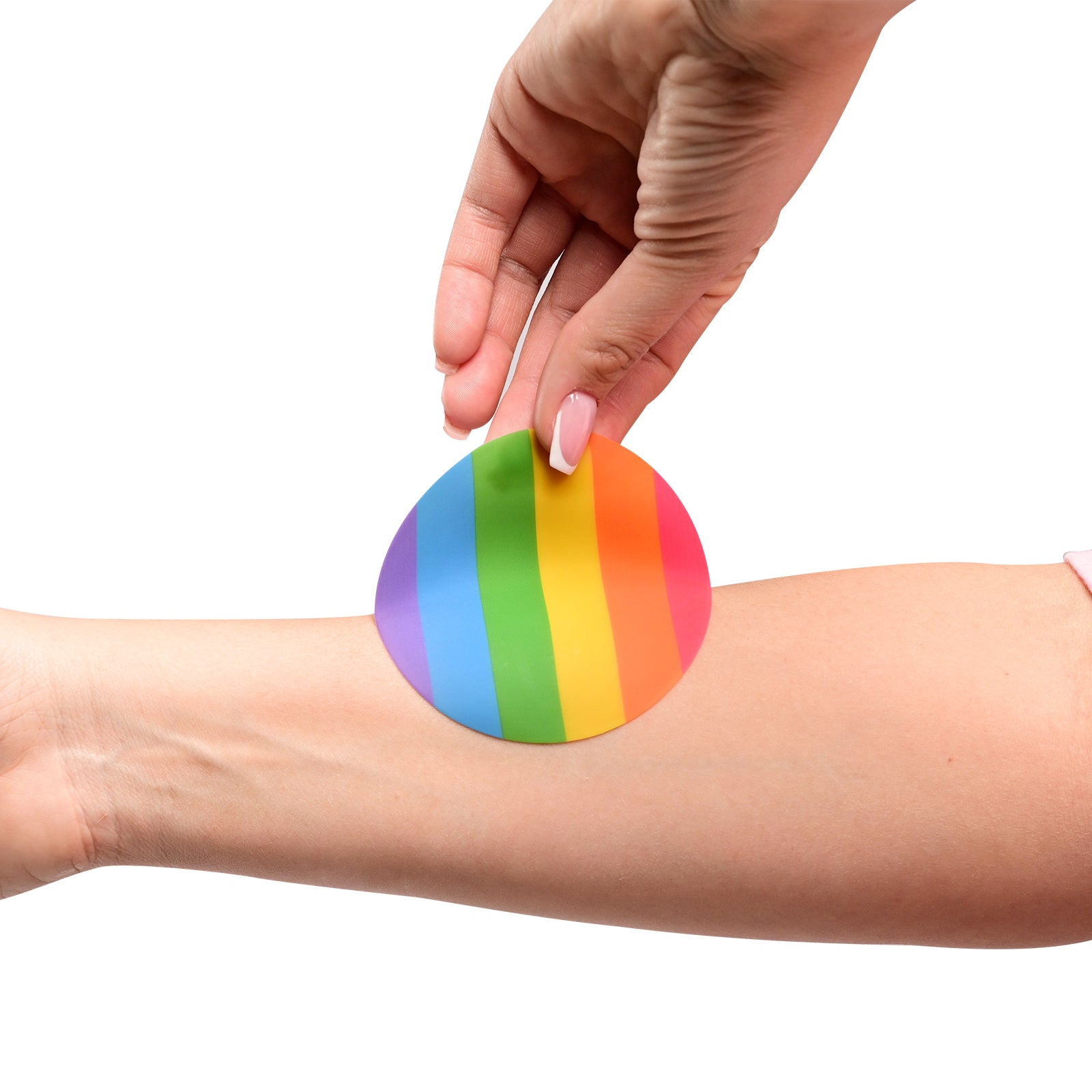 Hand applying Bare & Basic Love & Pride premium reusable nipple cover to a person's arm on a white background